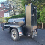 Used Meadow Creek TS120 Tank Smoker With Live Smoke, Insulated Firebox, Stainless Steel Exterior Shelves & Extra Grate in Warming Box